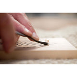 Woodcarver Carving a leaf