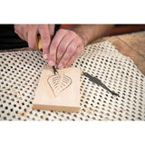 Woodcarver Carving a leaf